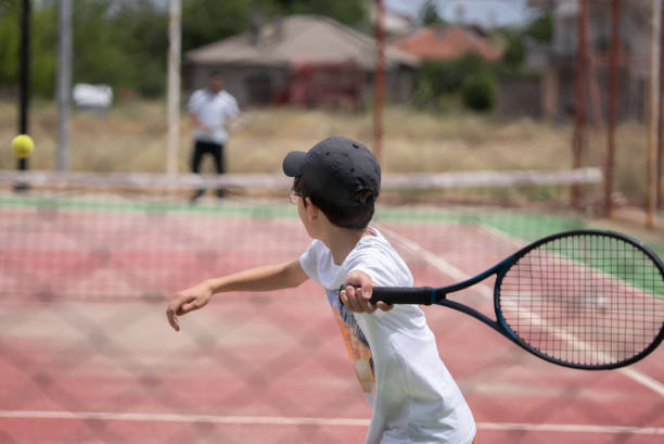 istock A boy playing tennis 1409349564