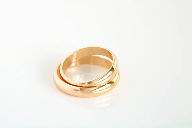 istock Gold wedding rings on a white. 1409349929