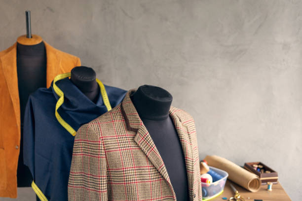 istock Suit jacket at tailor mannequin and sewing tools. Concept of clothes atelier workplace 1409350868