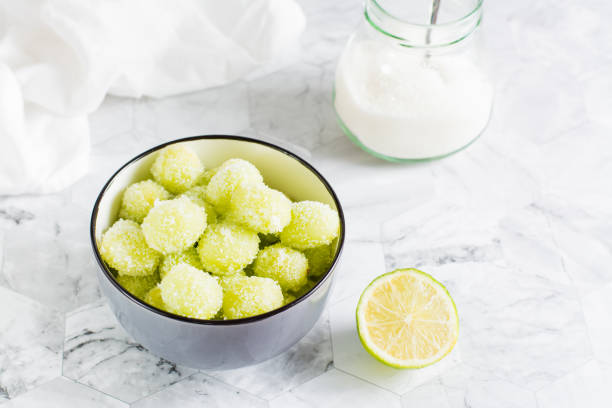 Sour candy grapes in a bowl, lime and sugar for cooking on the table. Social media candy trend. Sour candy grapes in a bowl, lime and sugar for cooking on the table. Social media candy trend. frozen grapes stock pictures, royalty-free photos & images