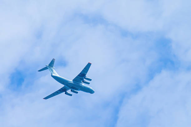 istock Airplane in blue sky. Air cargo transportation. Plane is flying 1409352085