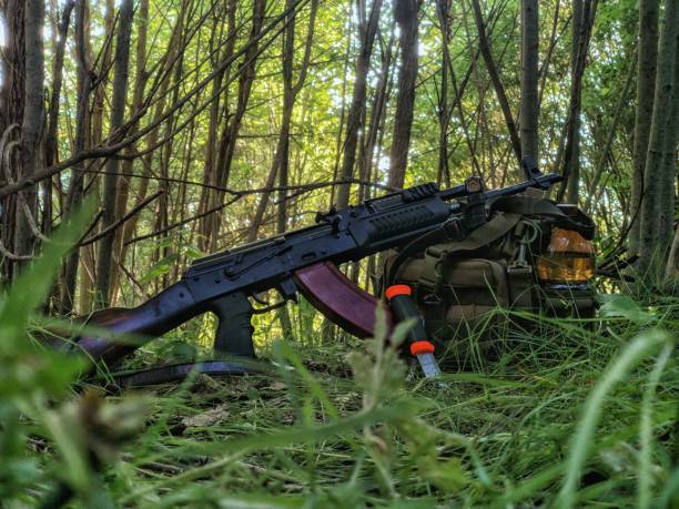 istock Rifle and knife in the woods 1409352920