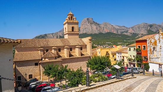 Panoramic view of the Church of San Pedro Apóstol in Polop de la Marina with the Sierra del Ponoig, ponoch or ponoitx behind, with its details of medieval architecture.