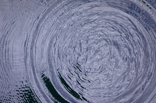 Circle ripple waves from rain droplet on water surface