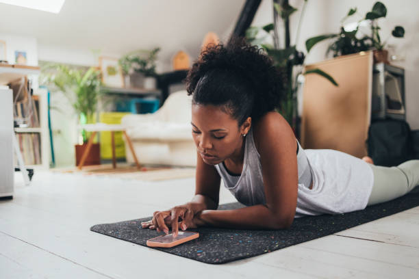 istock Woman Using Her Smartphone After Her Workout 1409356244