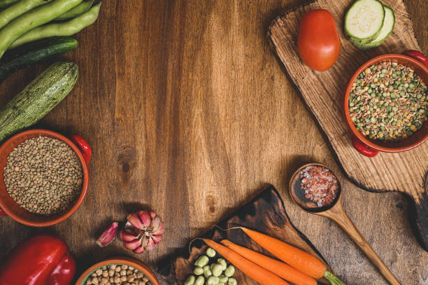 istock Clean organic farm vegetables. Frame of assorted fresh vegetables on rustic wooden table 1409358498