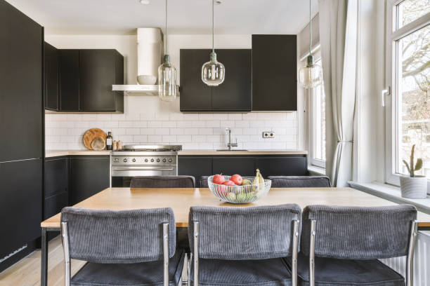 istock Small black kitchen with dining zone in modern apartment 1409361052