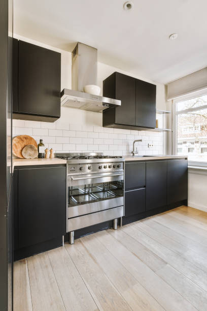 istock Small black kitchen near window in modern apartment 1409361055