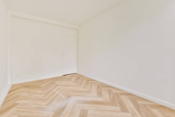 istock Empty room with white walls and parquet floor 1409363225