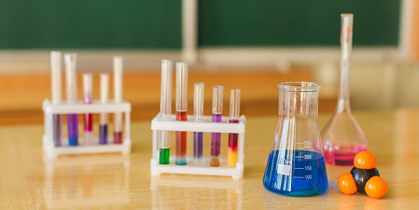 Color reagents in test tubes and flasks are on the table. Study chemistry. Natural Sciences. Desk. Classroom. Laboratory at the university. Biolaboratory. Science.