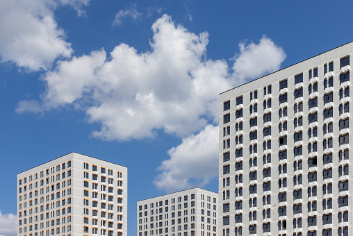 New modern residential apartment buildings district on blue cloudy sky