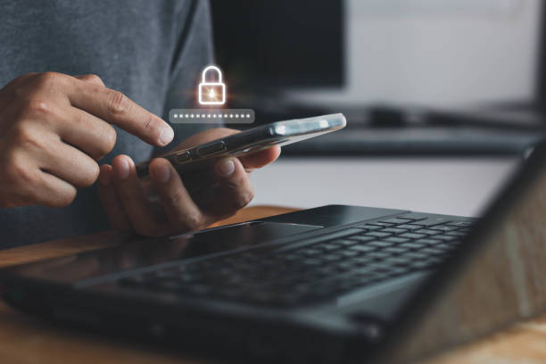 istock Asian businessman using the smart mobile phone to access on phone with laptop for validate password for biometric two steps authentication to unlock security, Business Technology security Concept 1409373653