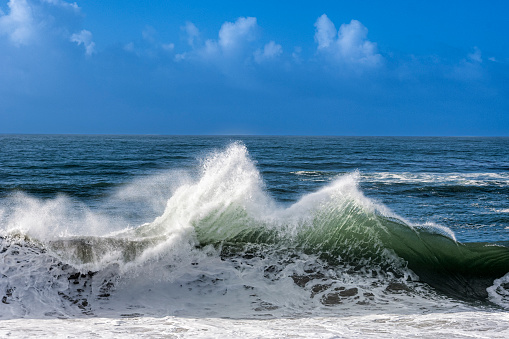 Turbulent ocean waves crashing on rocky shore, off the California Coast, after a pacific coast storm passed through the area.

Taken at Santa Cruz, California, USA