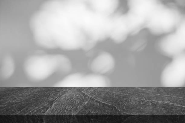 istock Marble table top with tree shadow drop on white wall background for mockup product display 1409374083