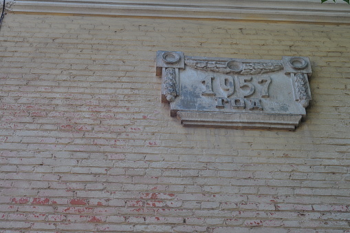 Plate made of concrete on the facade of the house with the year of construction 1957.
