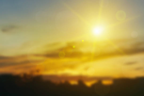 Relaxing outdoors vacation landscape concept: Abstract blurred sunlight beach colorful blurred bokeh background with retro effect autumn sunset sky have blue bright, white, and color orange calm.