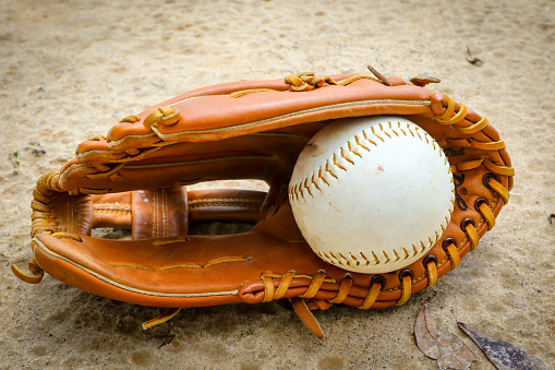 Close-up of Baseball Equipment including baseball glove and baseball at park in Central Florida