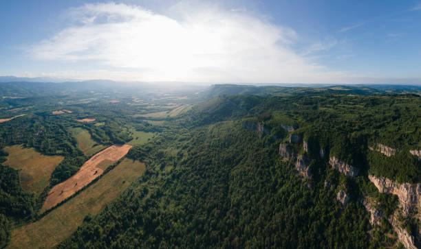 istock Mountain cliffs and spring green forests, aerial view. 1409376799