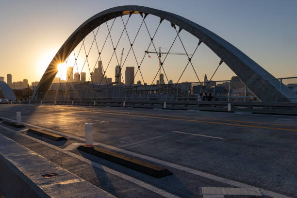 Sunstar at 6th street bridge Los Angeles, CA - July 14 2022:  Lens flare at sunset on the 6th street bridge in Los Angeles with the skyline in the distance sixth street bridge stock pictures, royalty-free photos & images