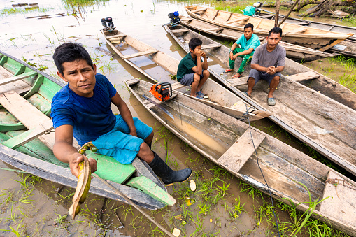 Amazonas, Colombia - February 17, 2022 The Ticuna (also Magüta, Tucuna, Tikuna, or Tukuna) are an indigenous people of Brazil , Colombia, and Peru, They living from tourism by selling their handicrafts and showing traditions to visitors also their livelihood resources is fishing.