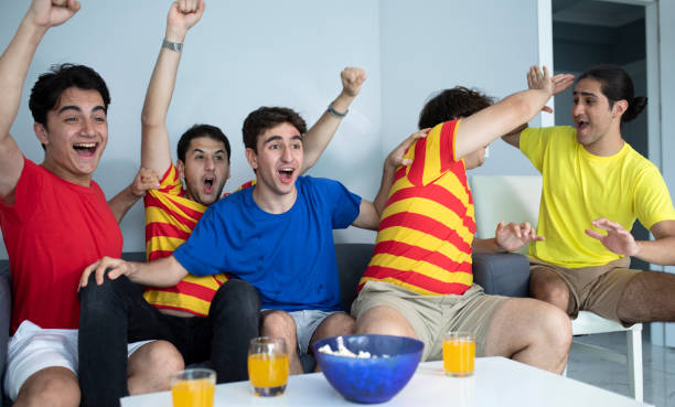 istock group of young man watching match on tv 1409385583