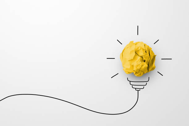 istock Creative thinking ideas and innovation concept. Paper scrap ball yellow colour with light bulb symbol on white background 1409386594