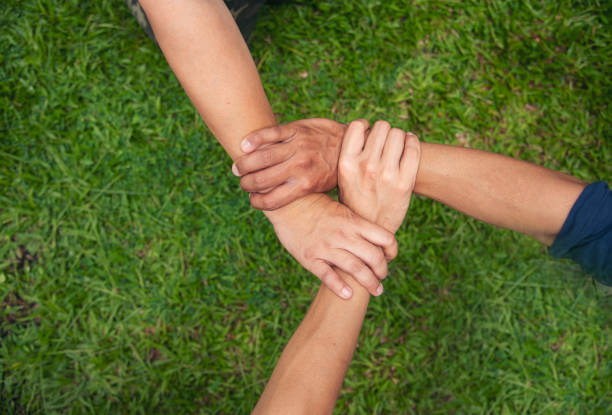 istock Close up hands Diverse multiethnic Partners team together. Teamwork group of multi racial people meeting join hands. Diversity people hands join empower partnership teams connect volunteer community 1409392741