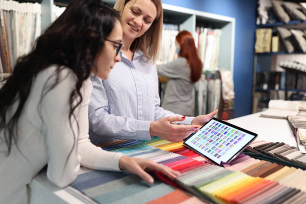 istock Designer and client examine color palette on tablet 1409396635
