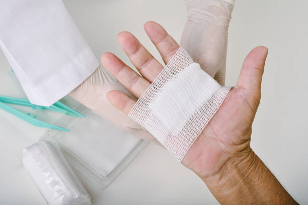 創傷被覆ケアや包帯患者さんの手、手の手術治療、看護師が病院で患者の指の怪我を治療しています。 - bandage ストックフォトと画像