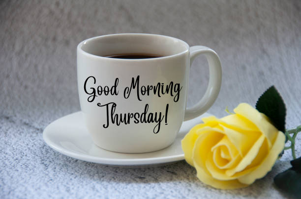 istock Good morning Thursday text on coffee cup yellow flower on blurred marble background. 1409407288