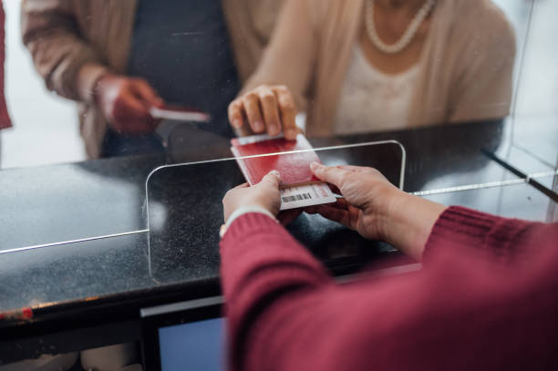 cropped image of passenger receiving boarding pass - customs imagens e fotografias de stock