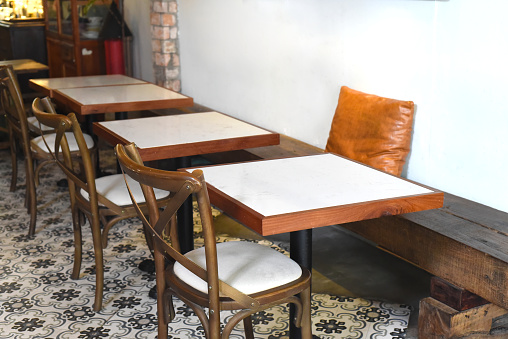 Wooden tables and chairs in a coffee shop