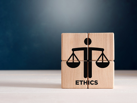 Business ethics or justice symbol on wooden cubes. Ethical corporate culture, business integrity and moral principles concept.