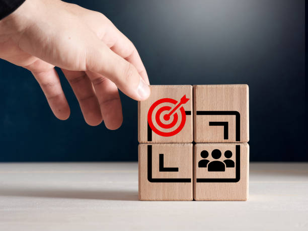 Wooden cubes with target and client group icons.