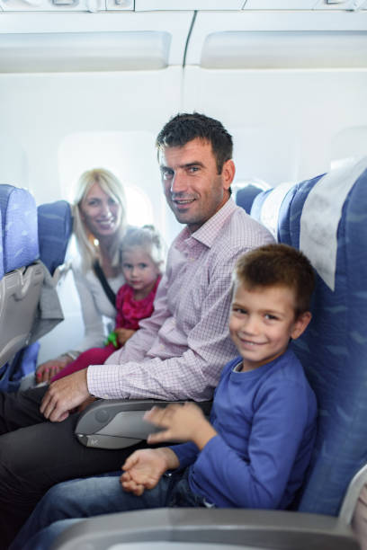 istock Happy family enjoying while traveling by plane. 1409419912
