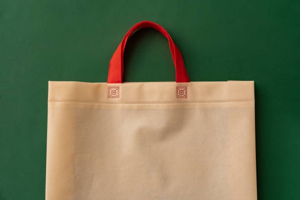 istock Textile shopping bag on green background flat lay 1409420371