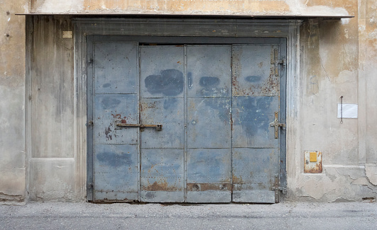 The ornament of the old doors is made of stone. Black-and-white fragment.