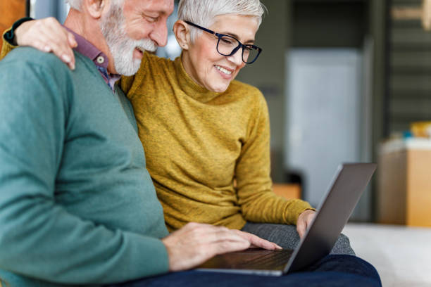 istock Happy senior couple using laptop at home. 1409420484