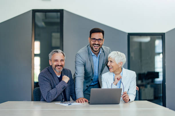 istock Happy people, at the office, working as a team, smiling. 1409422572