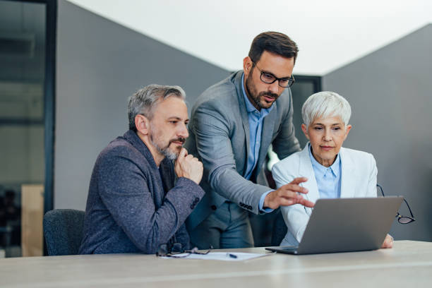 istock Focused businesspeople working online, having a conversation wit 1409422573