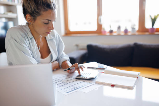 istock Woman paying bills from home 1409422639