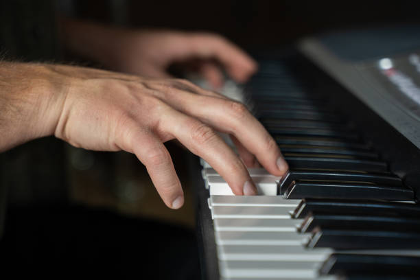 istock Man hands practice playing synthesizer and improvises 1409423502