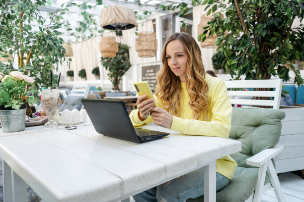 istock Young female freelancer work in cafe with netbook. 1409425416