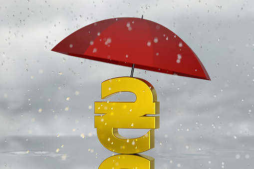 Umbrella Protecting Ukrainian Hryvnia symbol against the rain. Finance and Economy Concept.