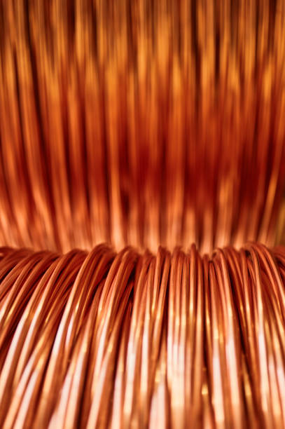 istock Large bobbin of orange copper wire in light warehouse 1409427106