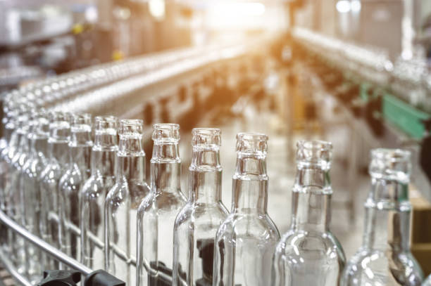 istock Row of glass bottles to fill with expensive alcohol drinks 1409427138