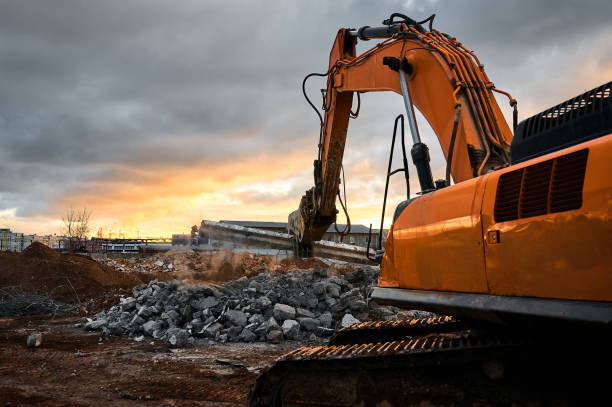 istock Excavator with concrete crusher on rig at demolition site 1409427179