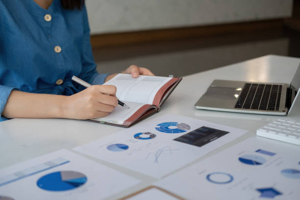 istock Bookkeeper or financial inspector hands making report taking note, calculating. Home finances, investment, economy, saving money or insurance concept 1409429772