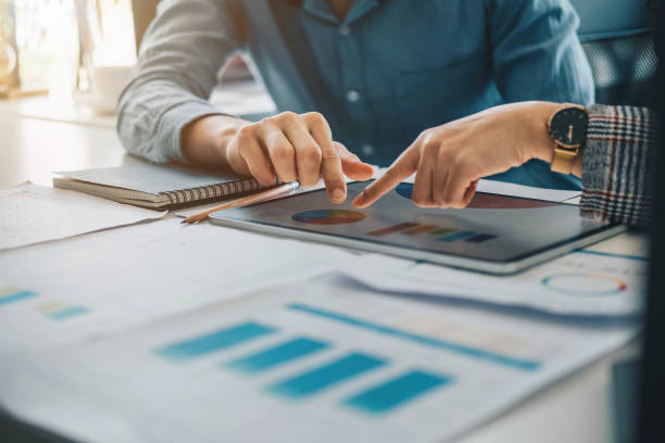 istock Group of IT consultant working by digital tablet and management big data and analyze financial document of company 1409429795