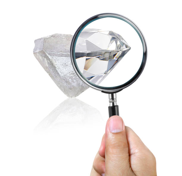 istock An expert examines through a magnifying glass. Searching For Value, diamond 1409429808